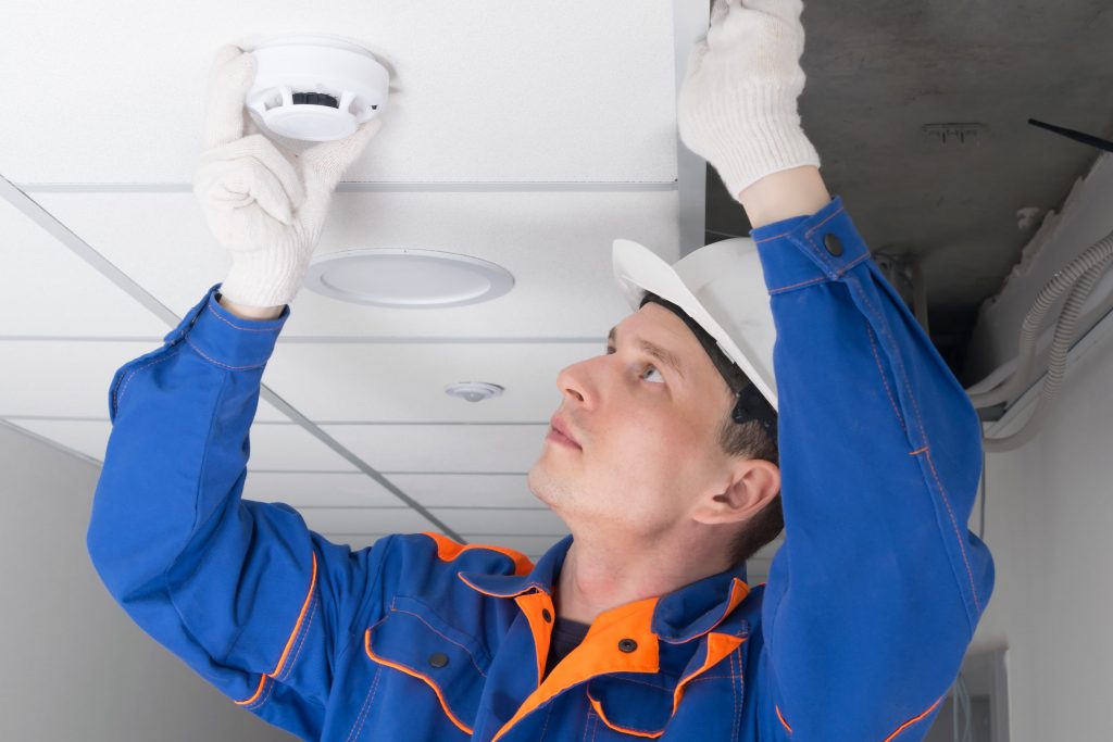 Electrician Replacing Smoke Alarm