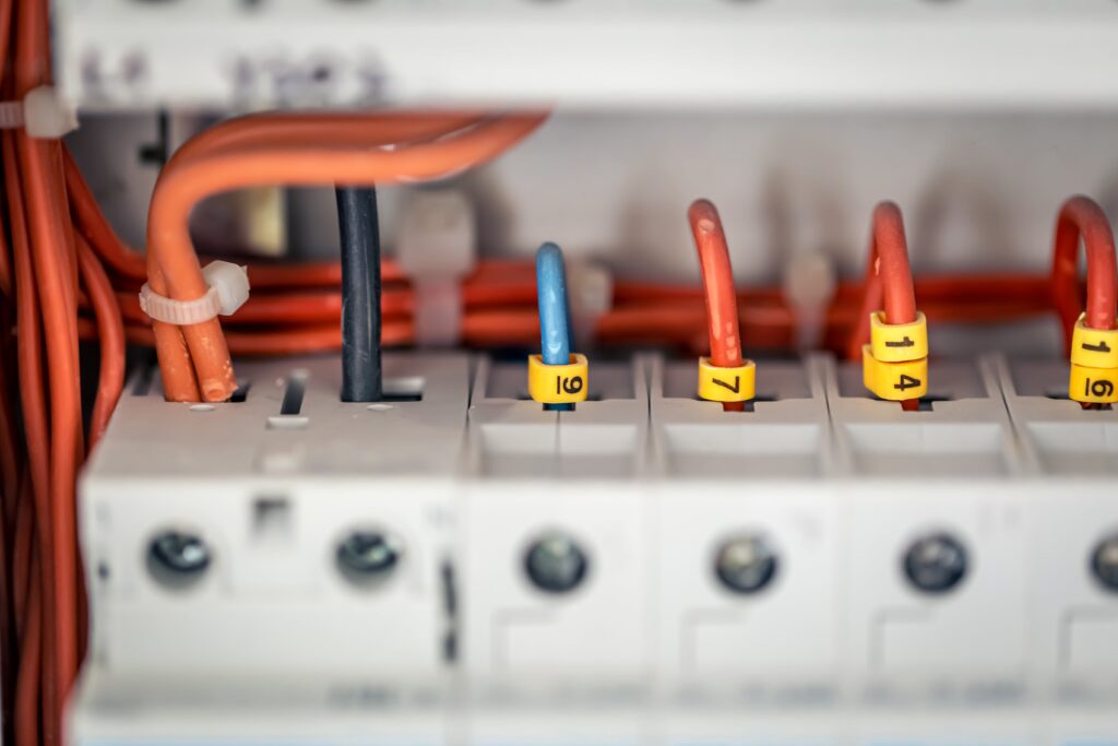 Close-up of Network Switch with Orange and White Ethernet cables