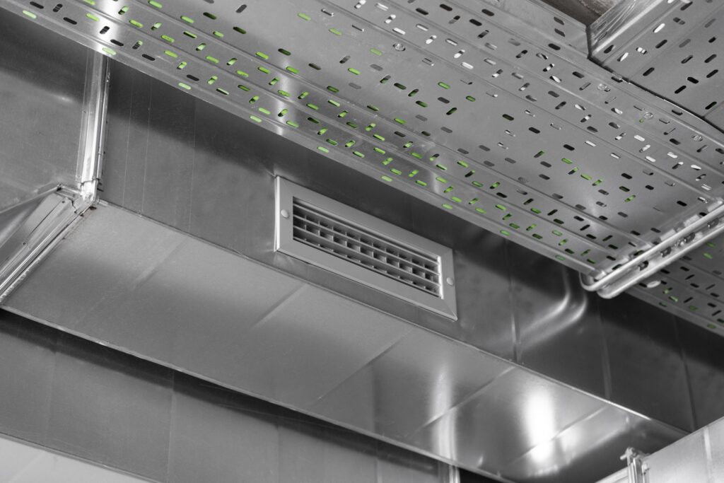 Rectangular Air Conditioning Vent in a Metal Duct System, Mounted to a Commercial Ceiling.
