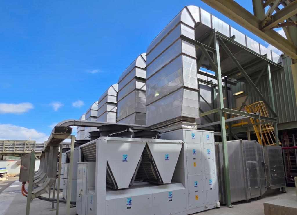 Close-up of two APAC 150 kW package units with insulated stainless steel ductwork installed at a WA mining processing plant